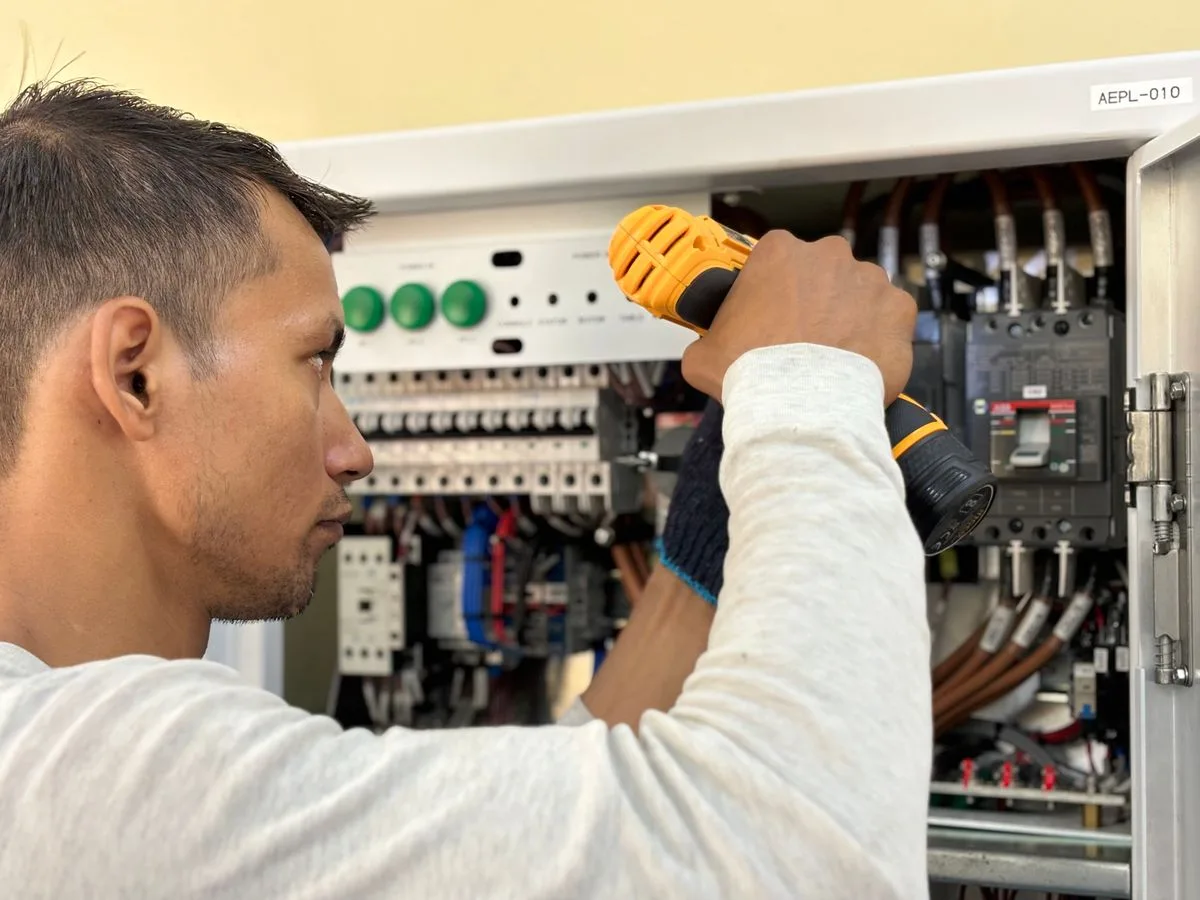 Electrician servicing an electrical panel