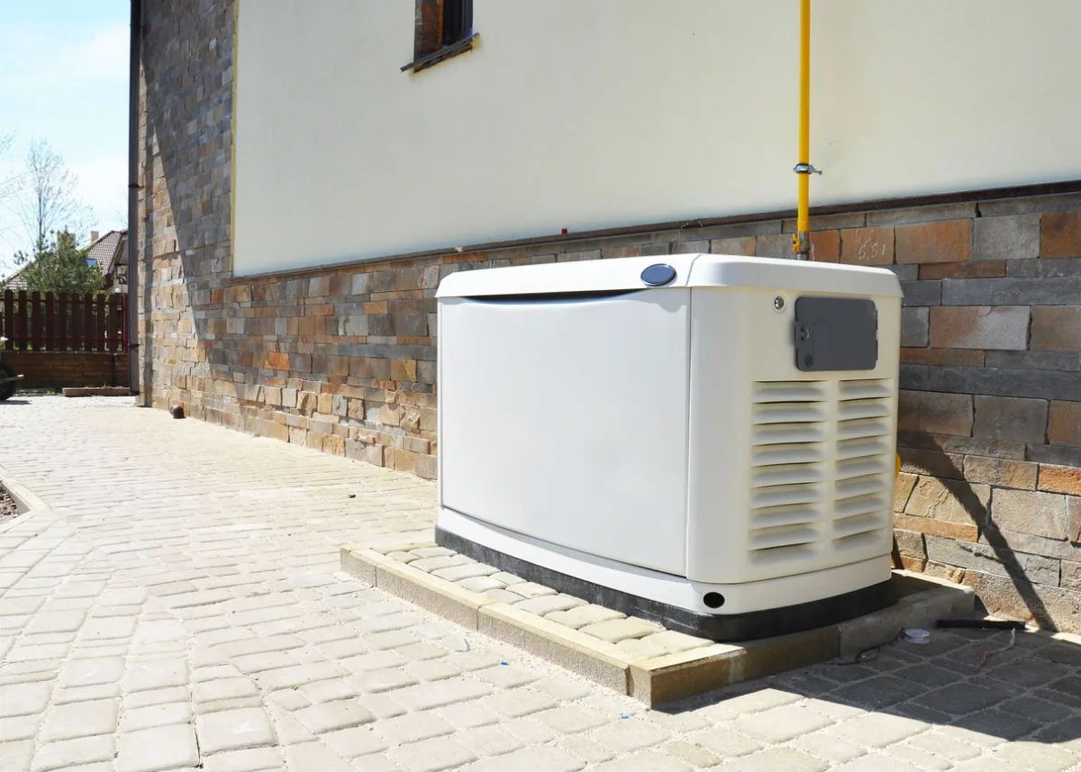 Whole-home standby generator installed beside a residence